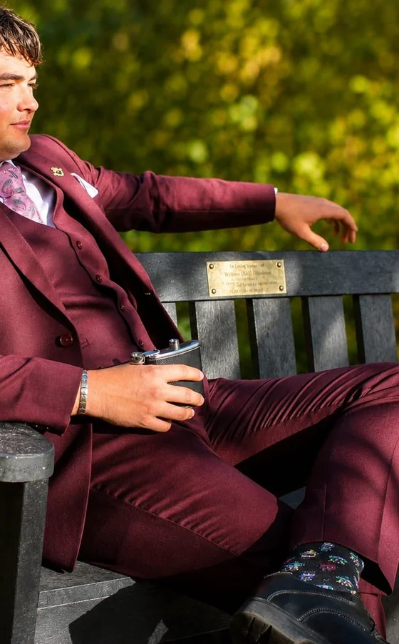 Flux client in a burgundy three-piece suit