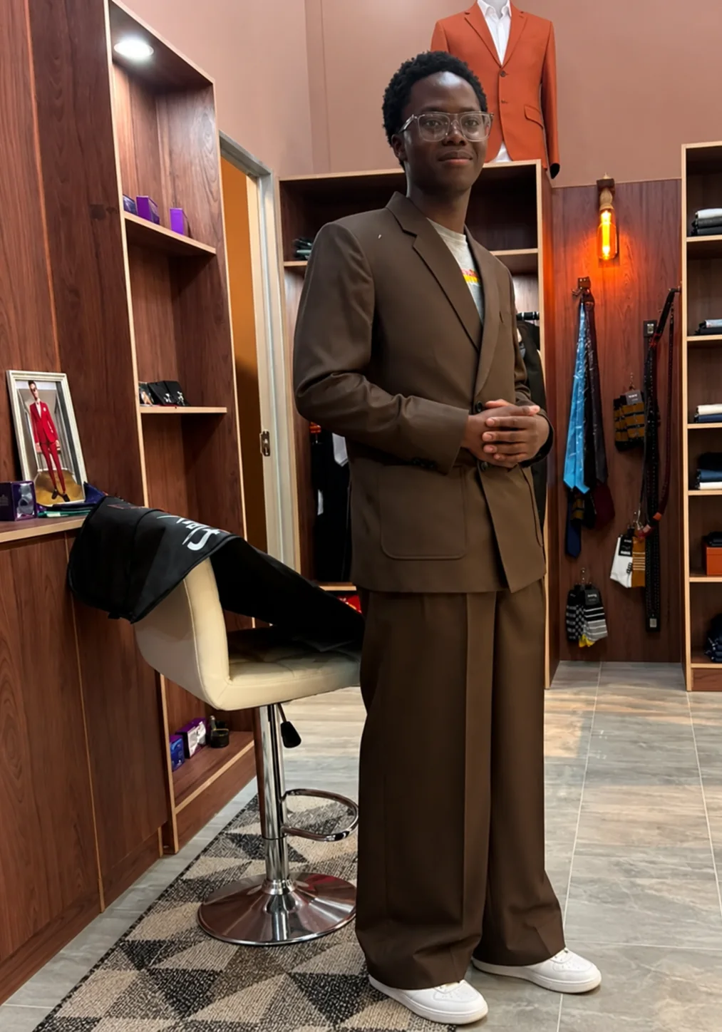 A Flux client in a brown wide-leg bespoke suit, photographed in the branch