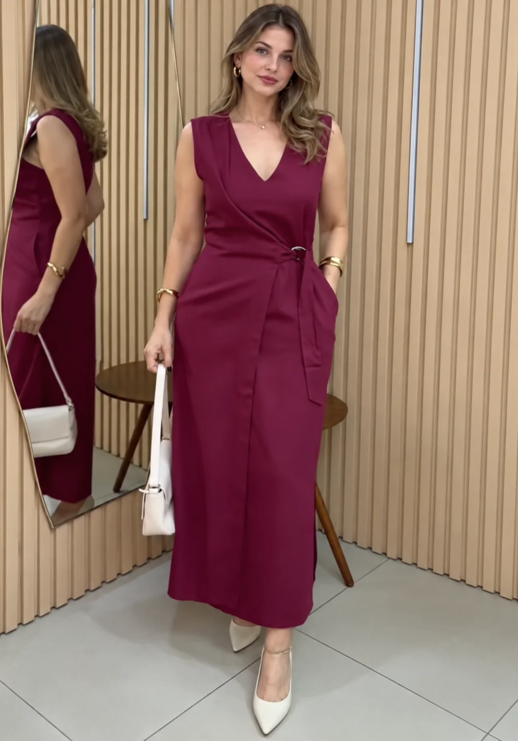 A woman in a tailored burgundy wrap dress, fitted at a Flux branch